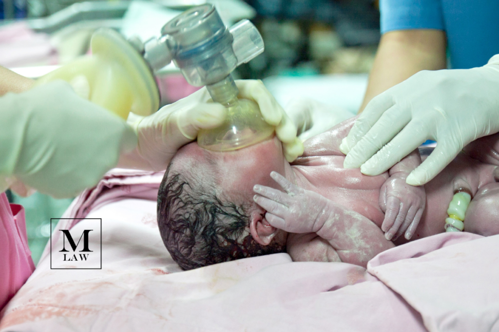 infant suffering from common birth injuries receives oxygen