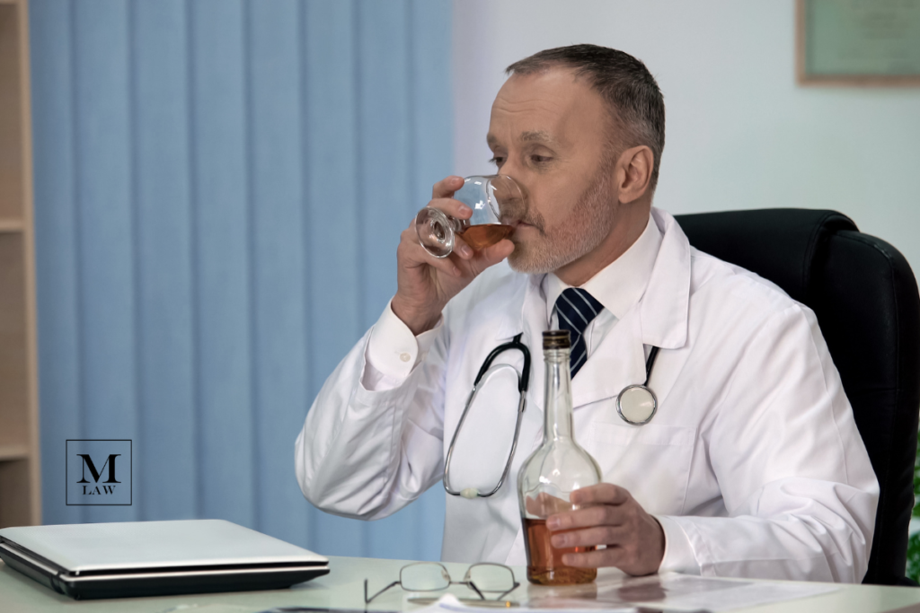 surgeon drinking at desk after making a surgical error