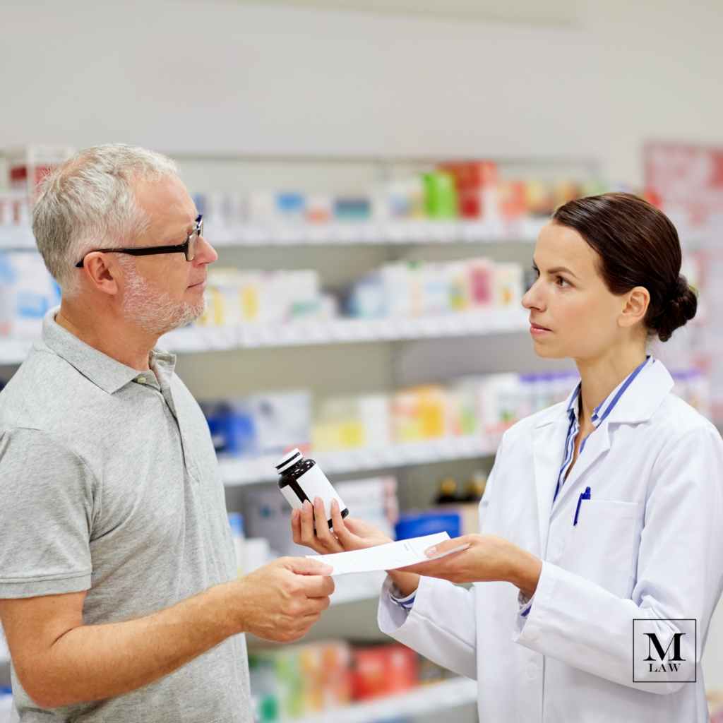 pharmacist handing a prescription medication to a patient